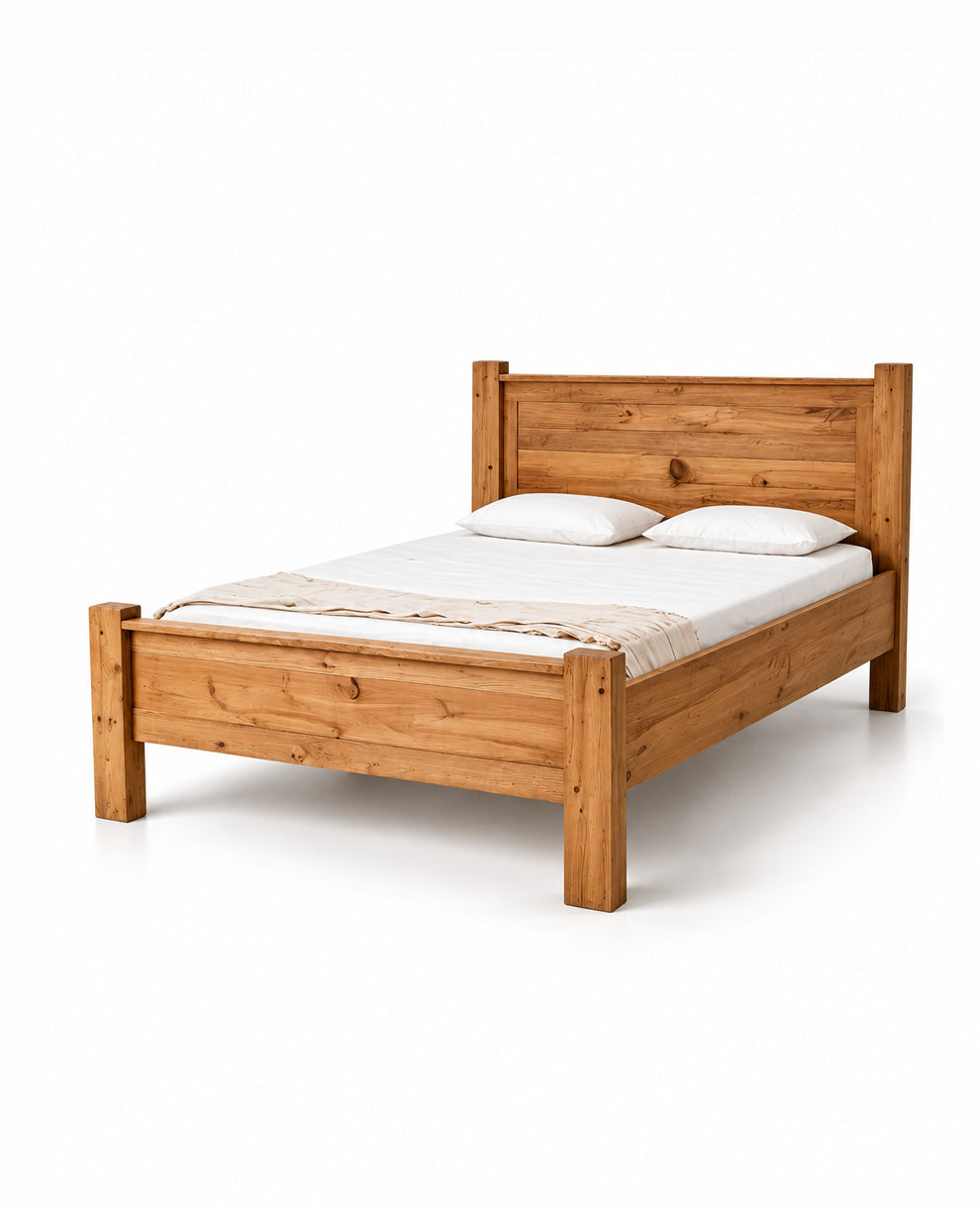 A rustic light brown wooden bed frame with a headboard and footboard, shown with a white mattress, two white pillows, and a beige throw blanket on a clean white background.