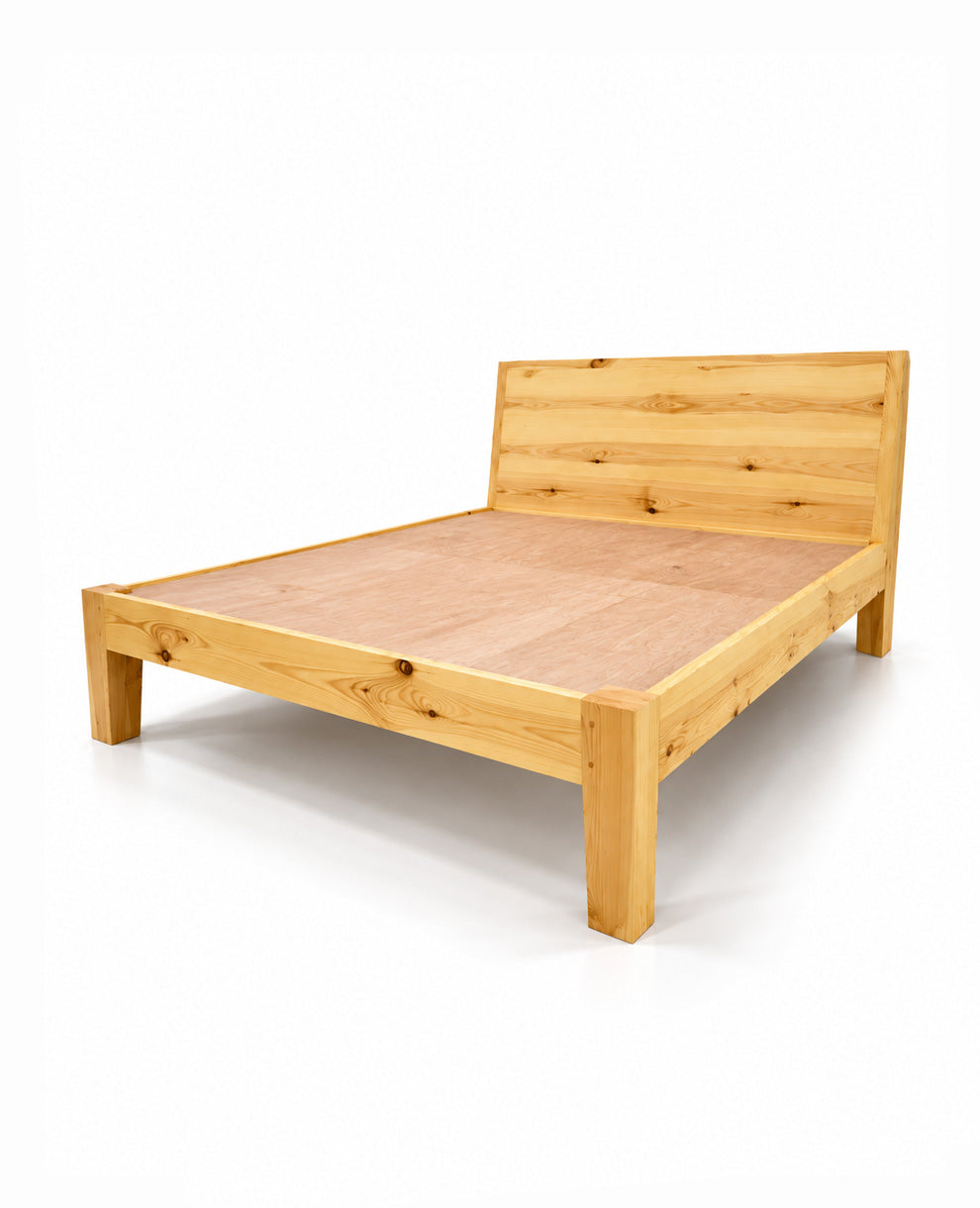 A light natural wood platform bed frame with a matching wooden headboard, shown from a three-quarters angle on a white background.