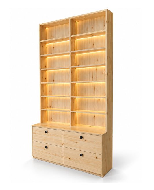 A tall light wood bookcase with two large shelving sections, illuminated by warm built-in LED strip lights, and a lower cabinet base with four drawers and small round black pulls, shown on a clean white background.