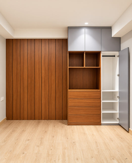 A modern built-in wardrobe or closet system with a large wood-paneled sliding door on the left, open wood shelving and drawers in the center, and gray upper cabinets with an open side door showing white interior shelves on the right.