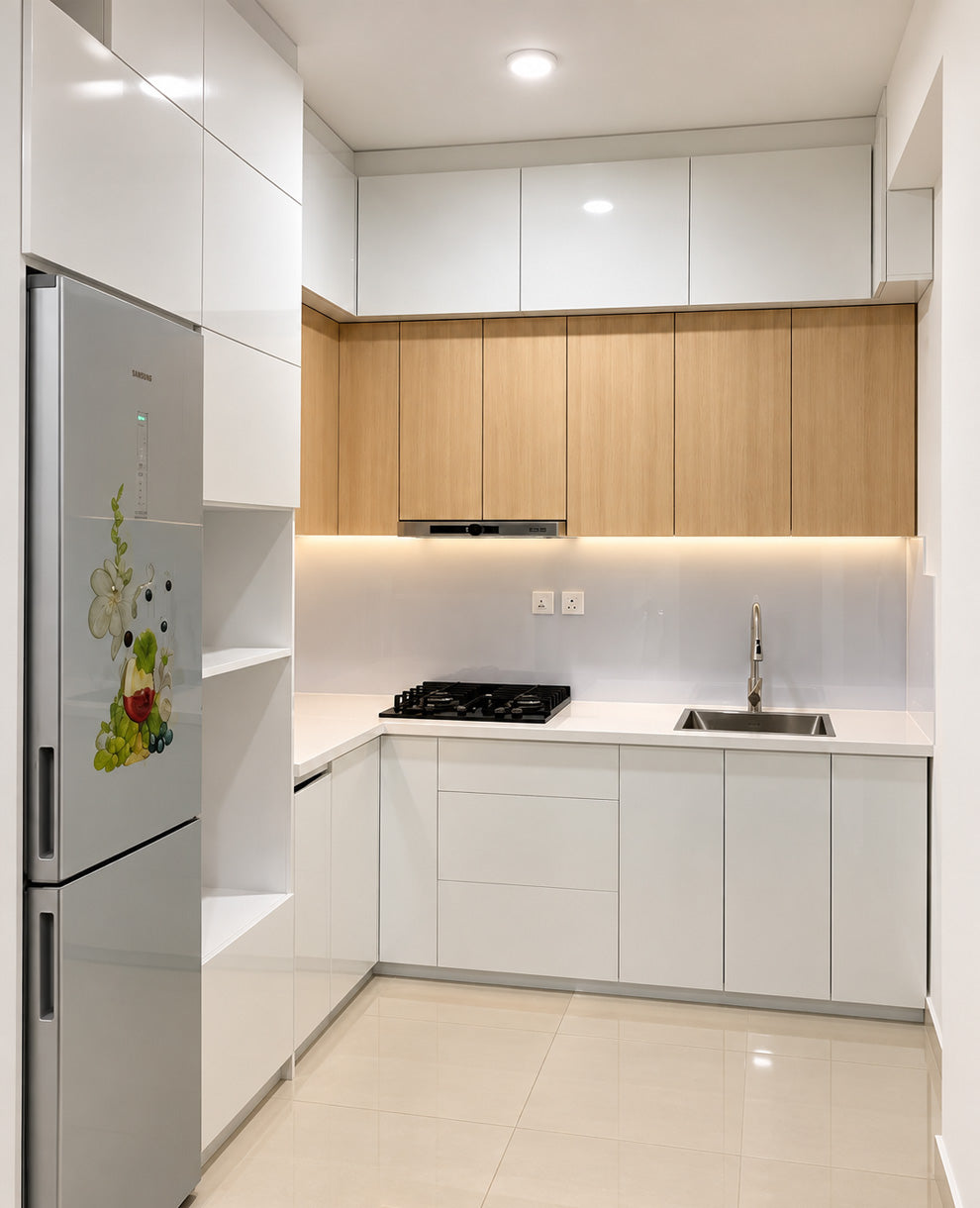 Modern kitchen interior with white cabinets, light wood upper cabinets, a stainless steel refrigerator, built-in gas cooktop, sink, and tiled floor.